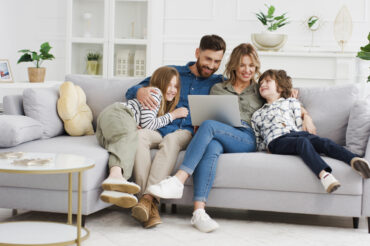 family sitting together on a couch