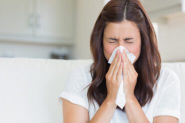 woman blowing her nose