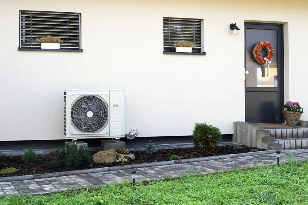 A heat pump situated outside of a customer's home.