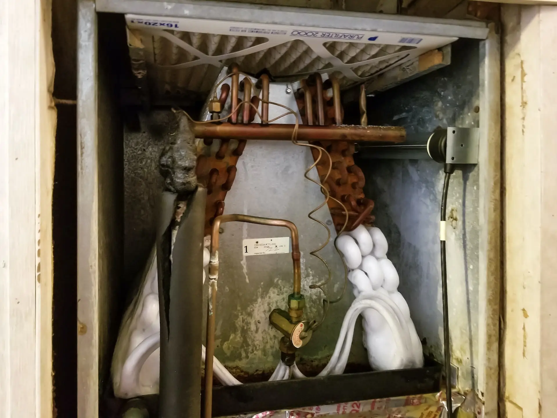 A frozen AC system and coils before service by Top Notch Heating, Cooling & Plumbing of Kansas City.