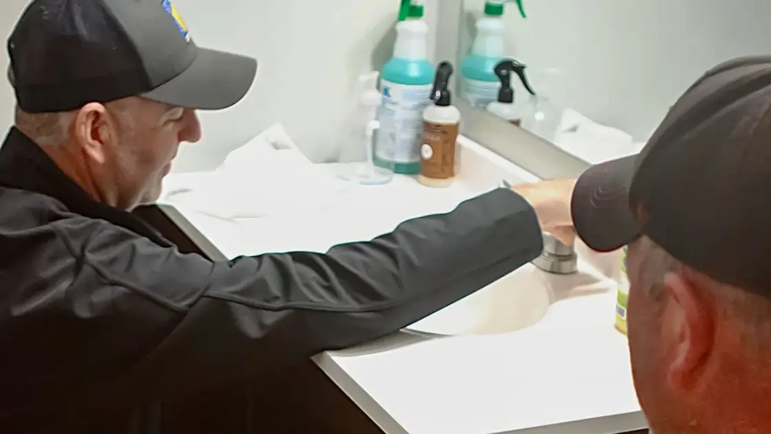 A Top Notch Heating, Cooling & Plumbing technician performing plumbing services on a Kansas City property.