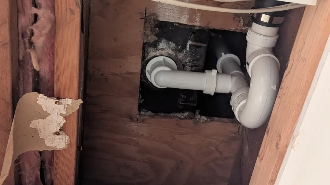 Water damage from kitchen sink plumbing issues in a Kansas City home, by Top Notch Heating, Cooling & Plumbing.