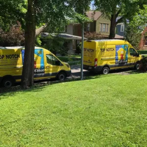 Top Notch Heating, Cooling & Plumbing vans outside Kansas City home